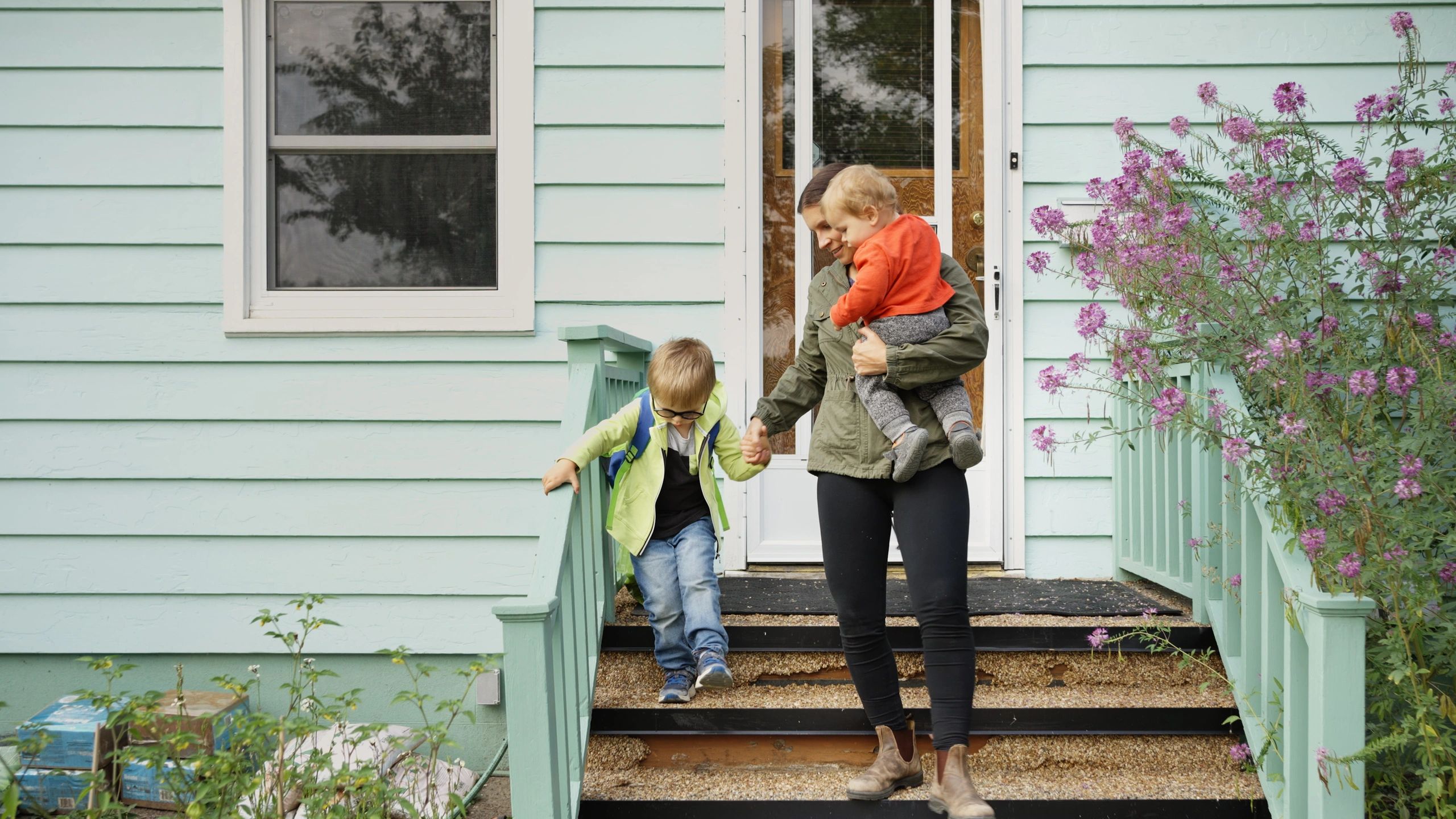 Mother and children leaving their home