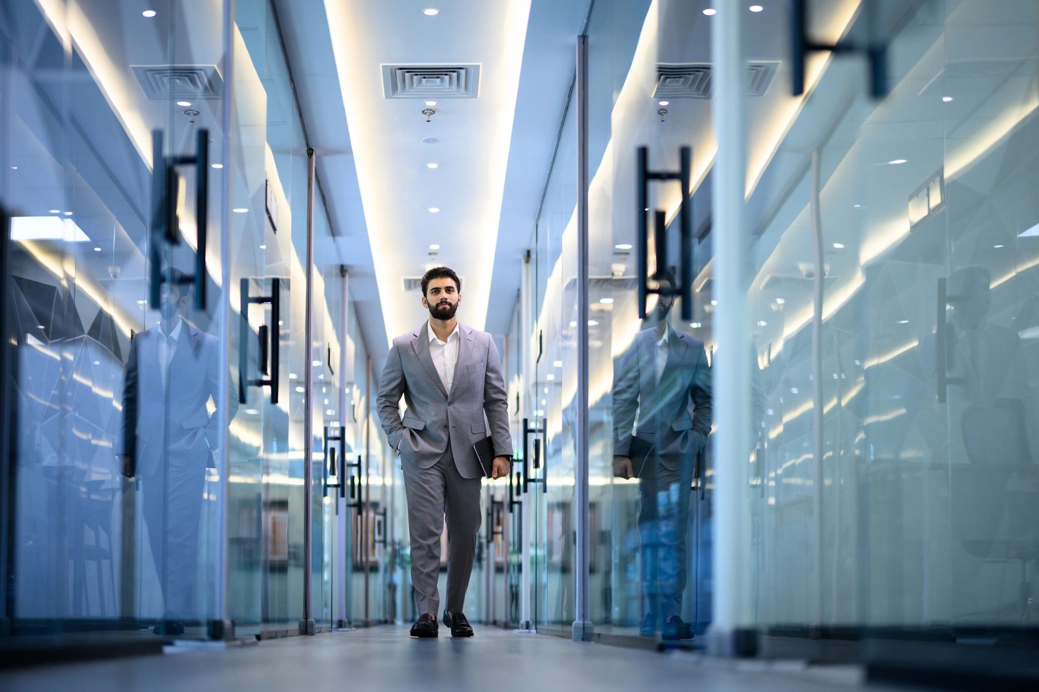 Business professional walking through a modern office corridor